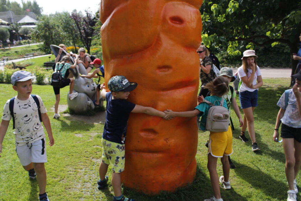 Dzieci obejmują dużą marchewkę.